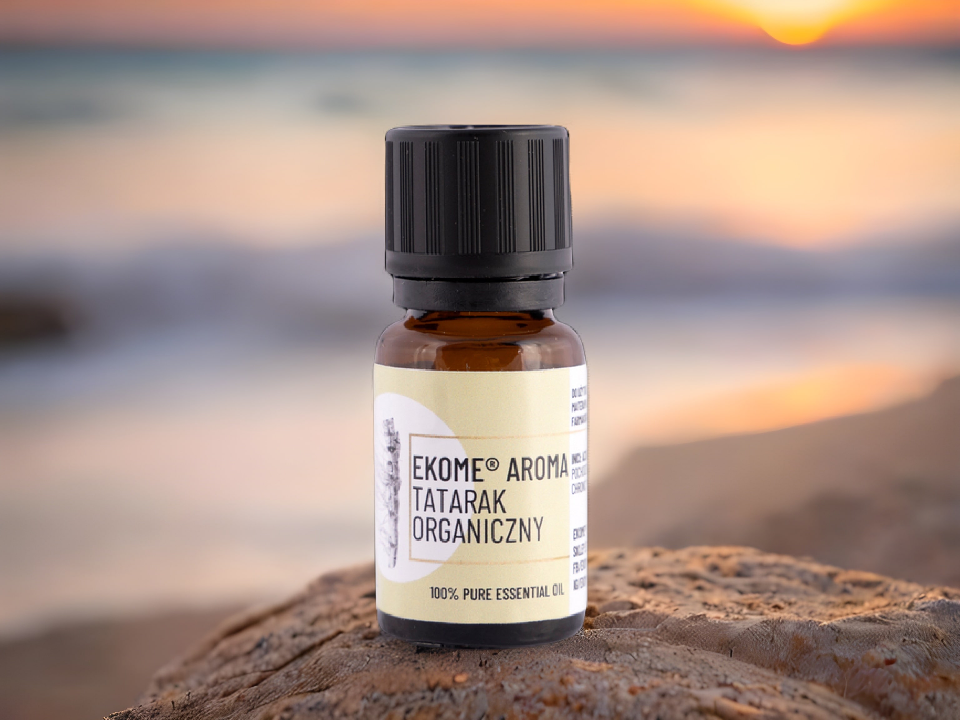 Tatarak organiczny olejek eteryczny Ekome® 10 ml - buteleczka na tle zachodu słońca